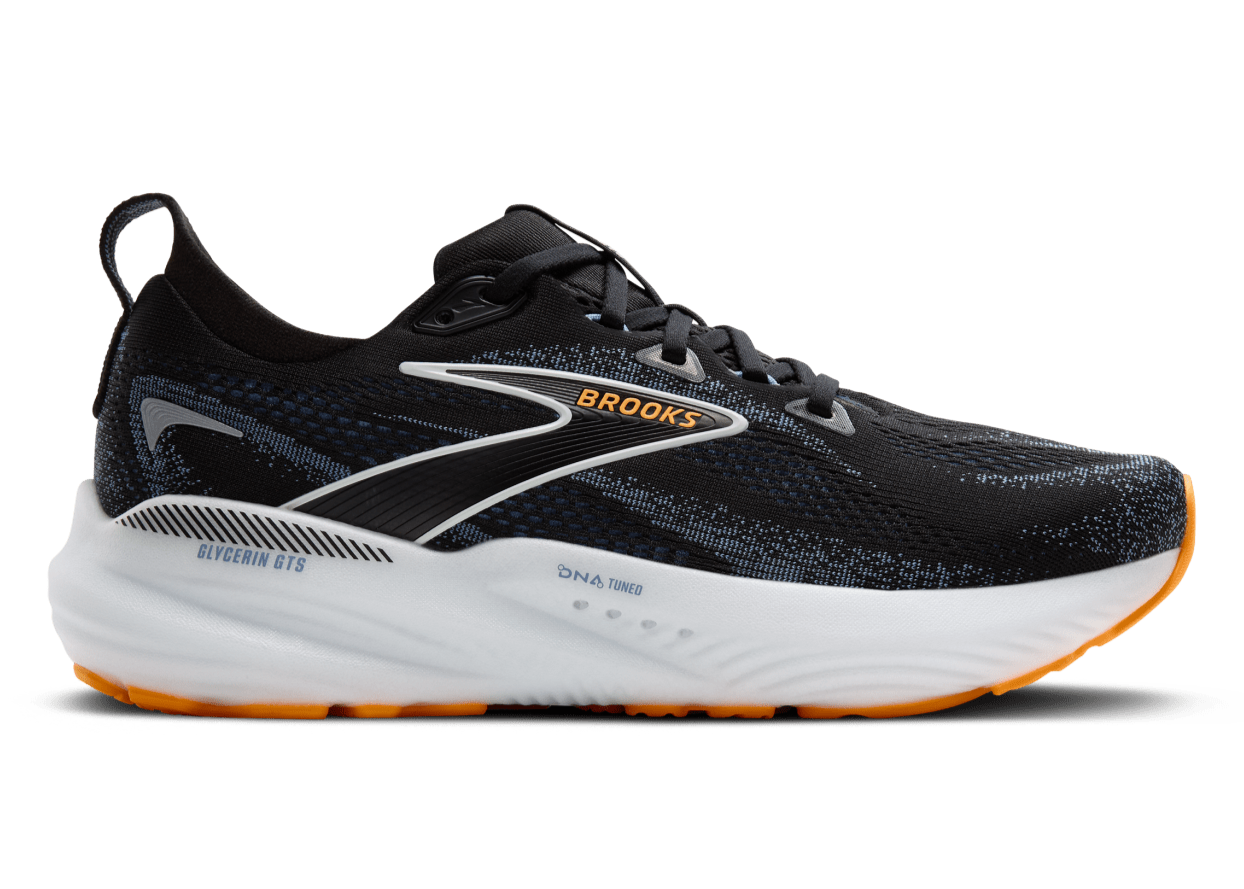 Black running shoe with white sole on a transparent background