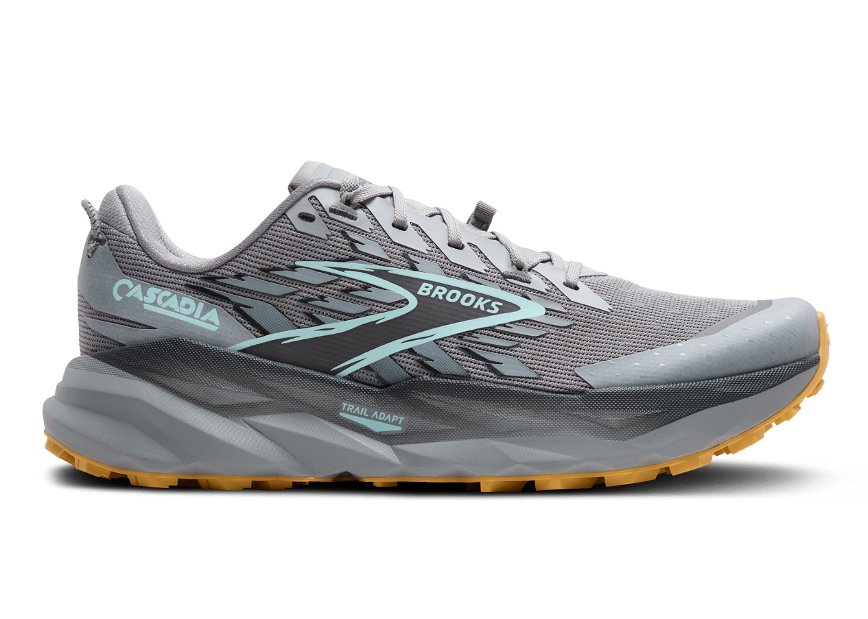 Gray running shoe with yellow sole on a white background