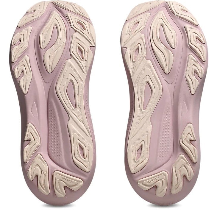 Pair of pink and beige shoes with unique sole design on a white background