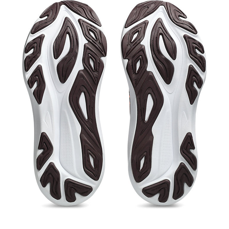 Close-up of white athletic shoes with brown pattern on a white background