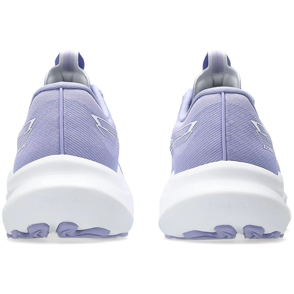 Purple running shoes with white soles on a white background