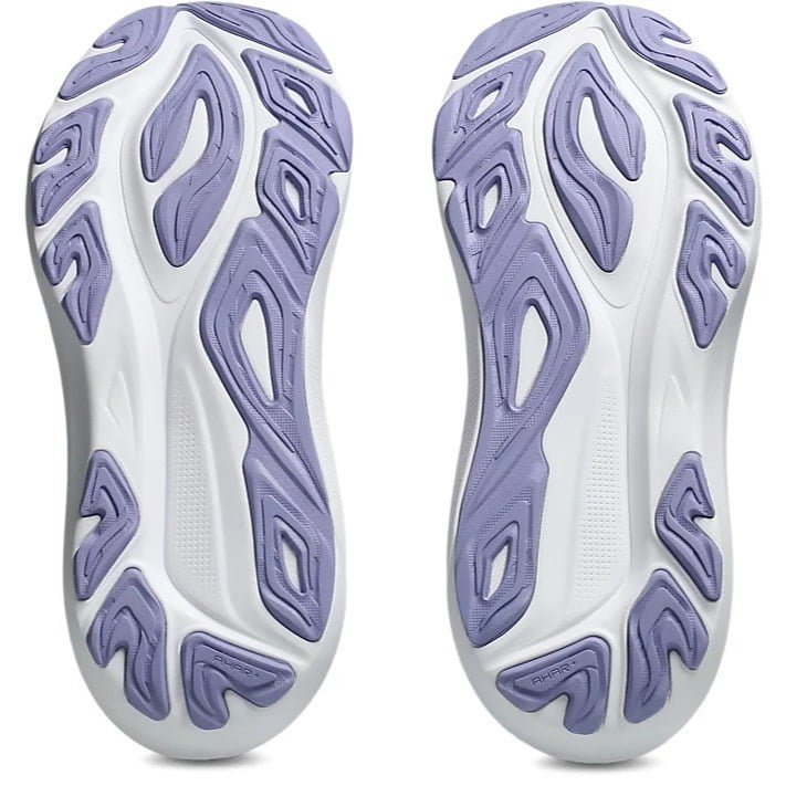 Close-up of white and purple athletic shoe soles on a white background