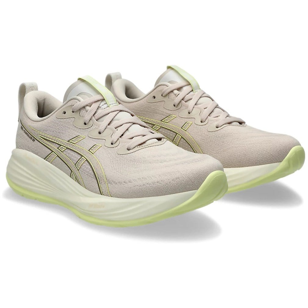 Beige running shoes with green accents on a white background