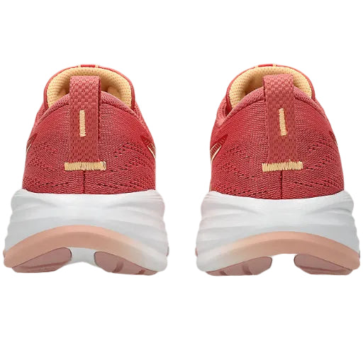 Red running shoes with white soles on a white background