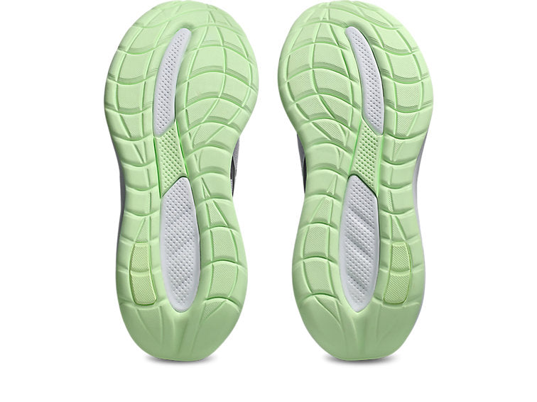 Light green athletic shoes with tread pattern on a white background