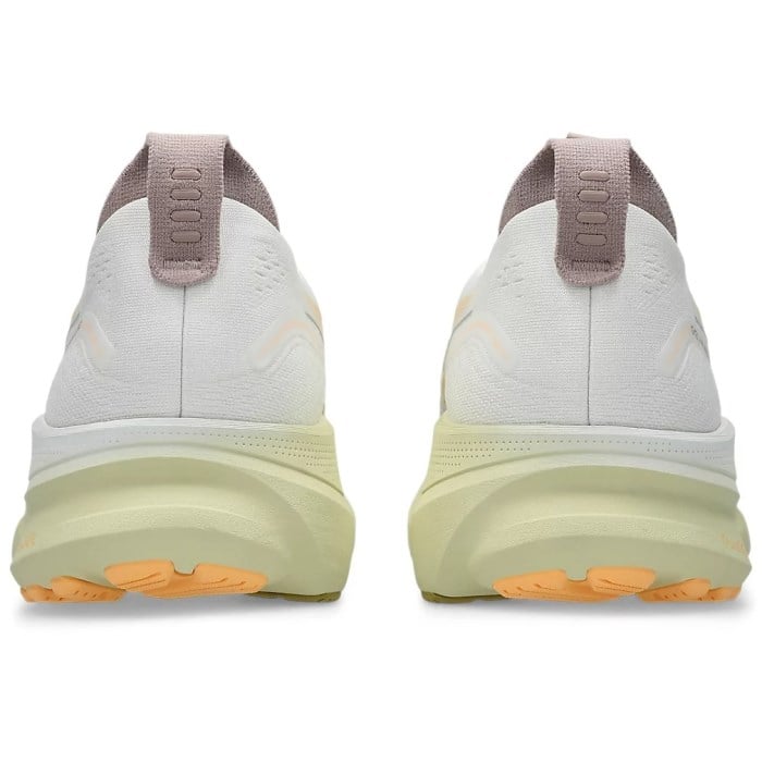 White running shoes with orange sole on a white background