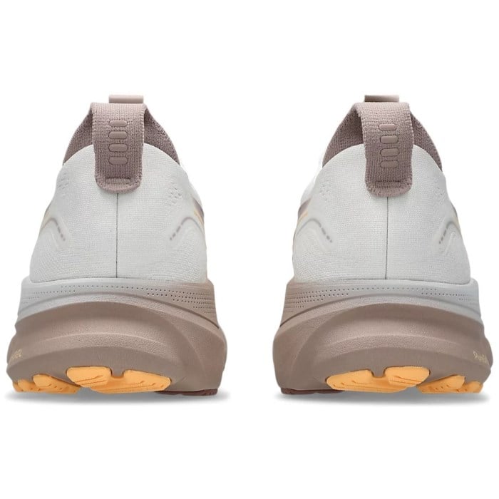 Pair of white and brown shoes with orange sole on a white background