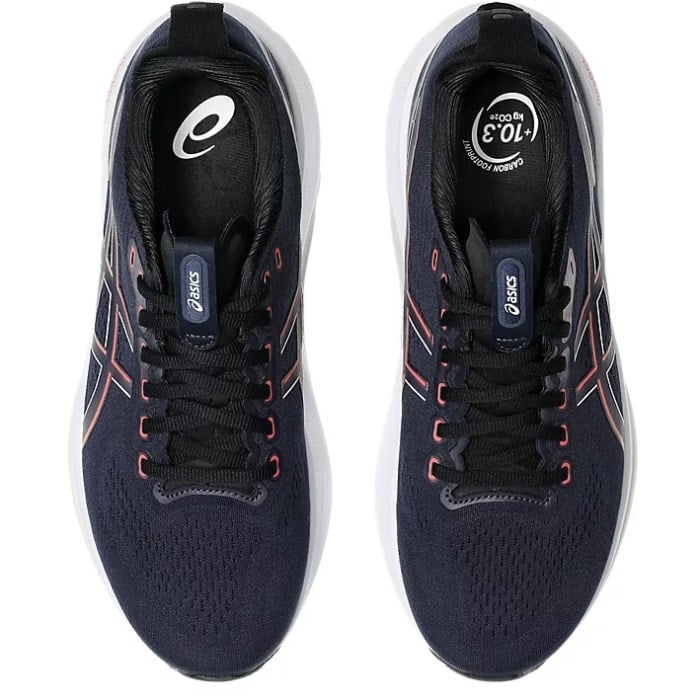 Navy running shoes with white sole on a white background