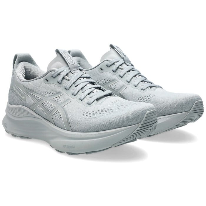 Pair of light gray running shoes on a white background