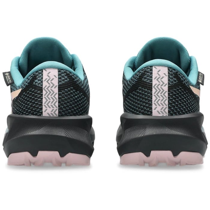 Back view of black and teal running shoes with pink soles on a white background