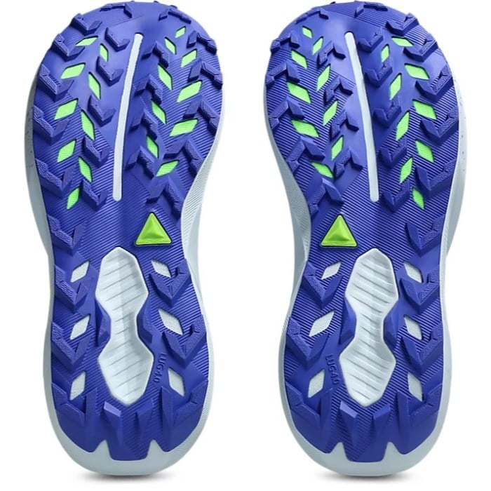 Close-up of blue athletic shoes with green accents on a white background