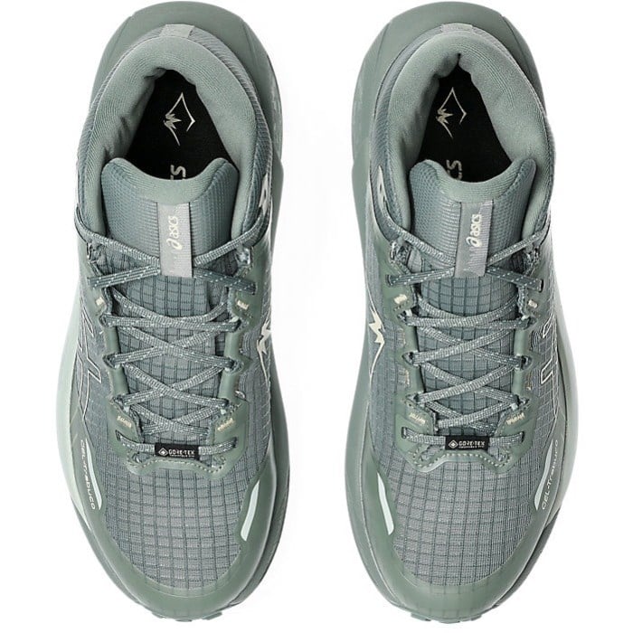 Pair of gray athletic shoes with laces on a white background