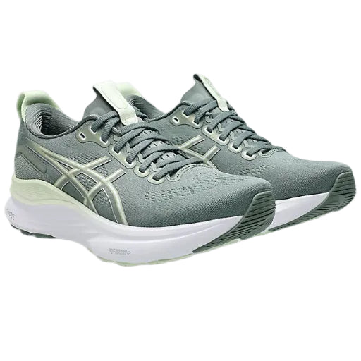 Gray running shoes with white soles on a light gray background