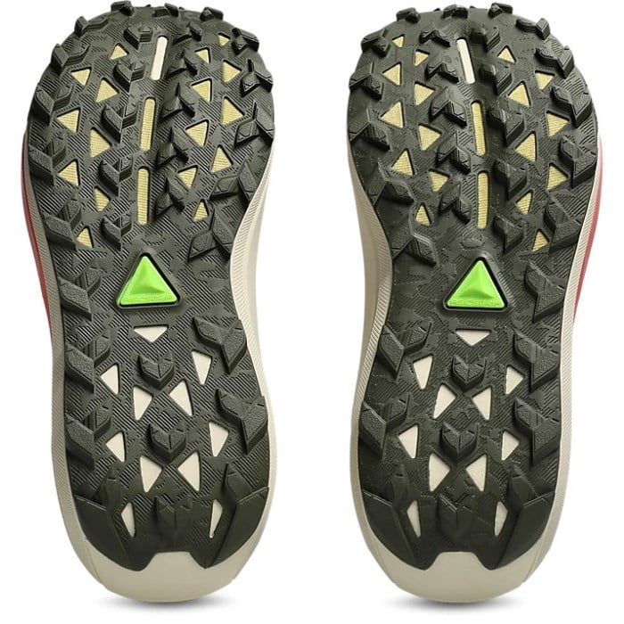 Close-up of a pair of hiking shoes with textured sole and green triangle logo on a white background