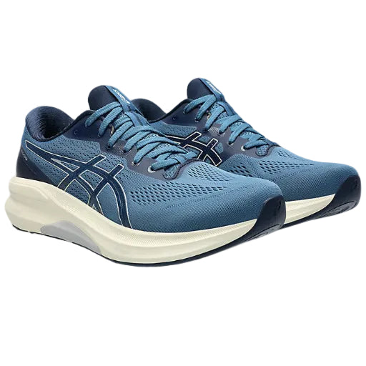 Blue running shoes with white soles on a white background