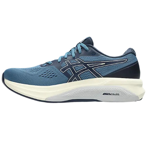 Blue running shoe with white sole on a white background