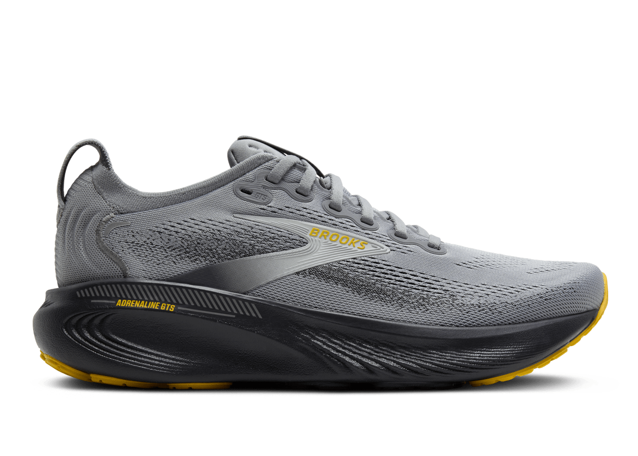 Gray running shoe with black sole on a white background