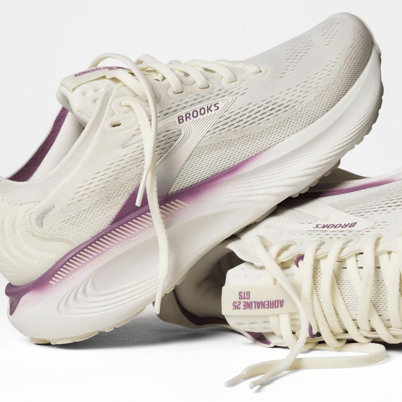 White running shoes with purple accents and 'Brooks' branding on a white background