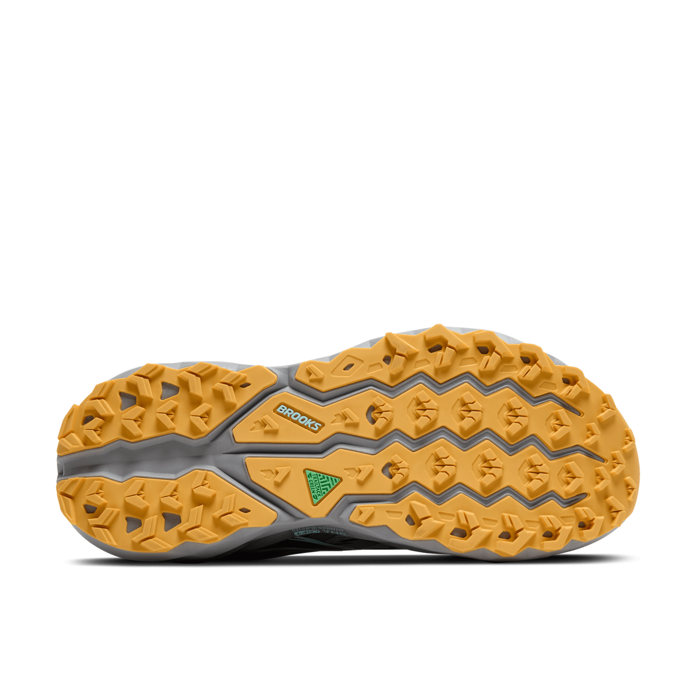 Close-up of a yellow and gray shoe sole with 'Brooks' branding on a green background