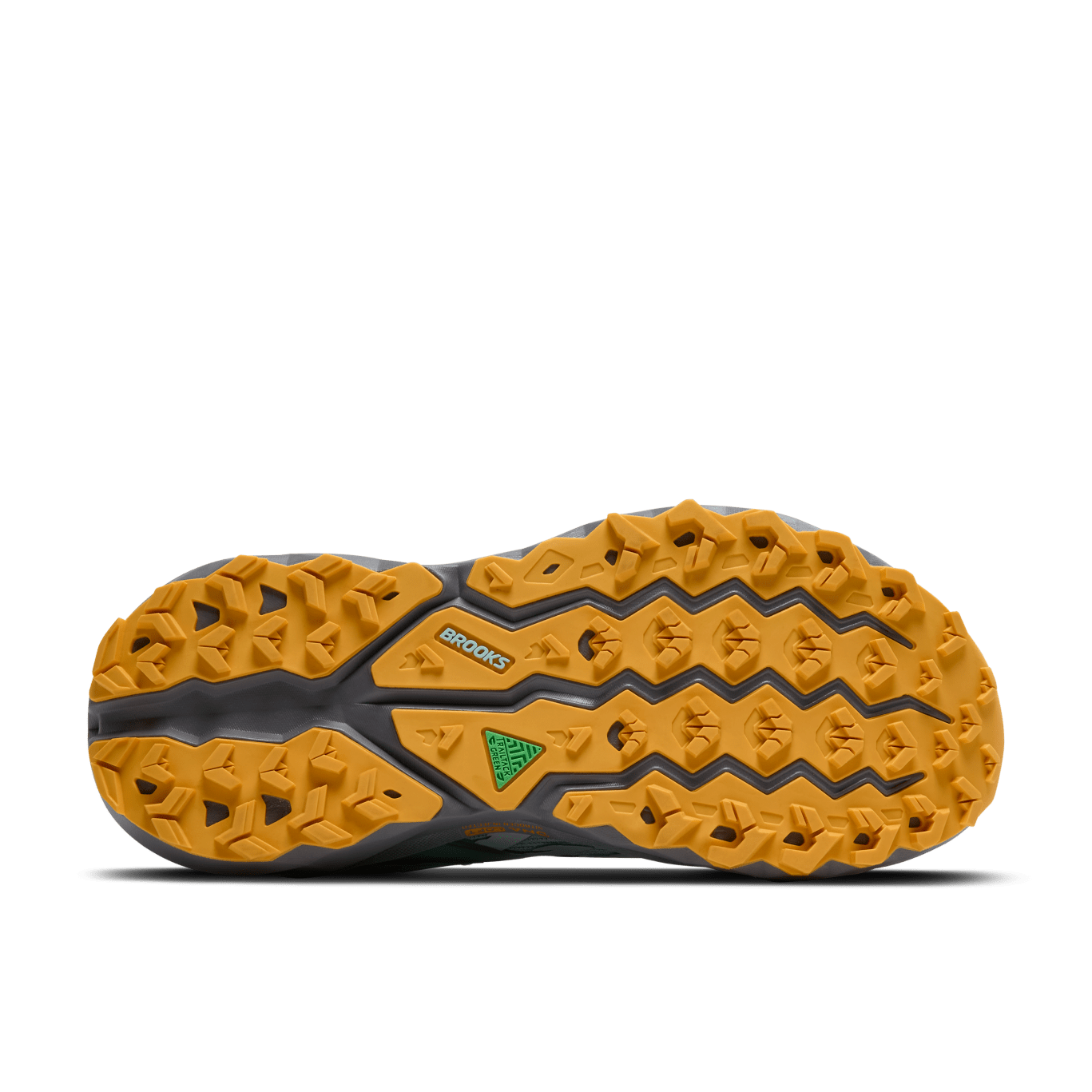 Close-up of a shoe sole with yellow tread pattern on a green background