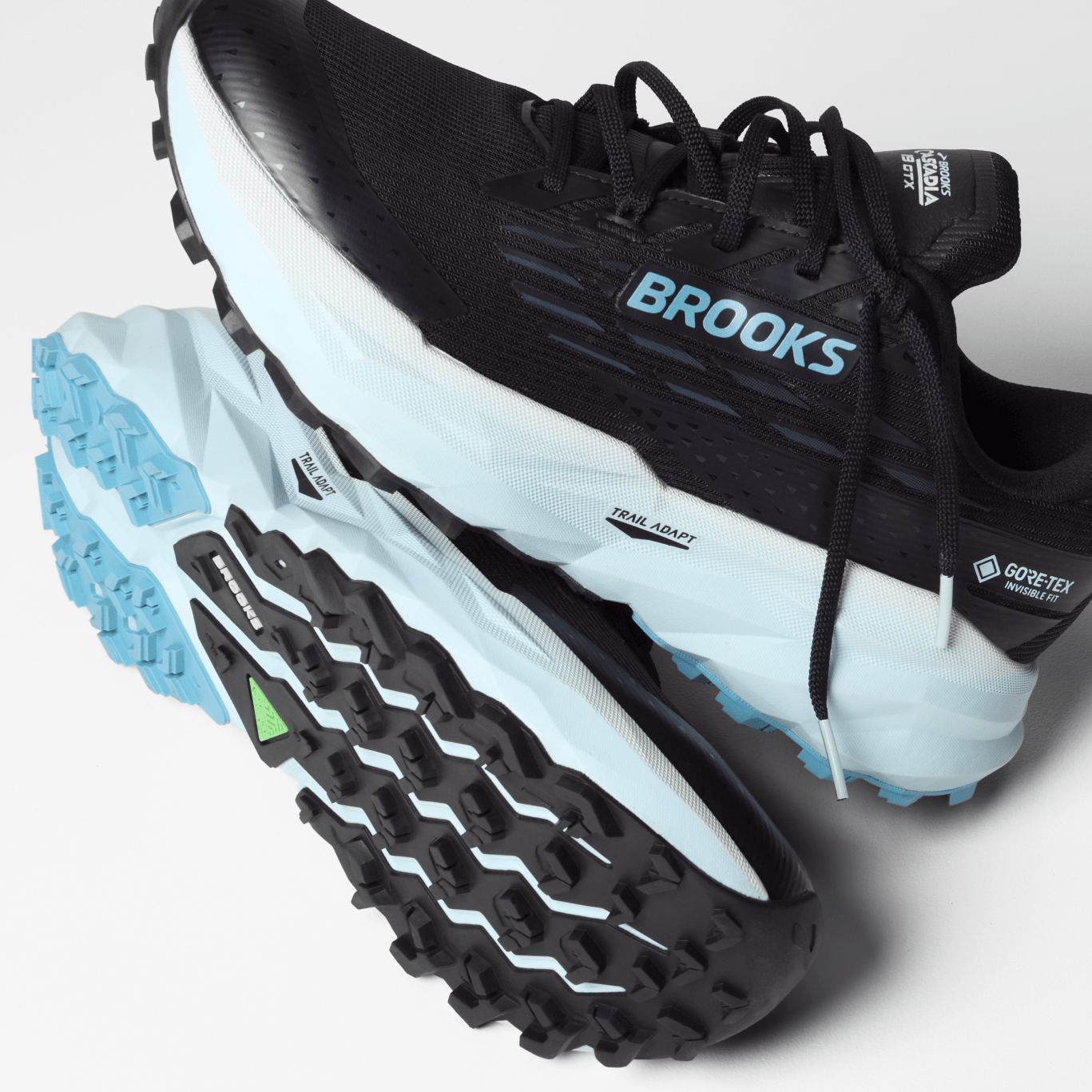Black and blue running shoe with 'Brooks' branding on a light gray background