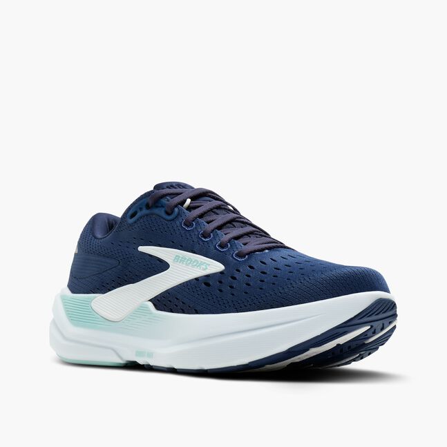 Navy running shoe with white sole on a light gray background