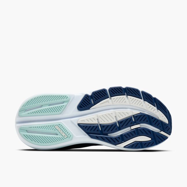 Navy and white running shoe with green accents on a white background