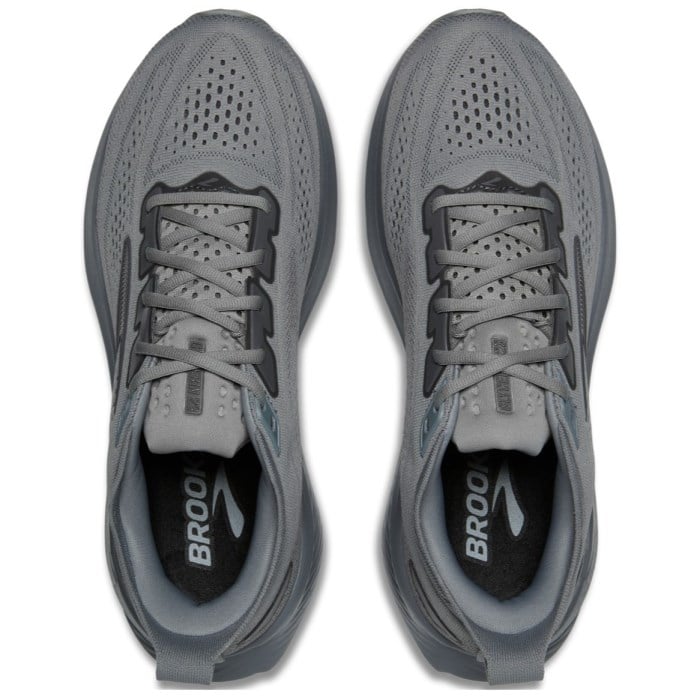 Pair of gray running shoes with 'Brooks' branding on a white background