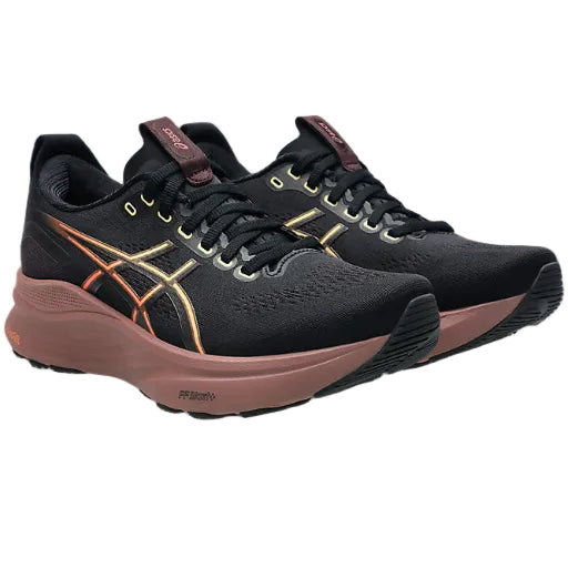 Black and brown running shoes with gold accents on a white background
