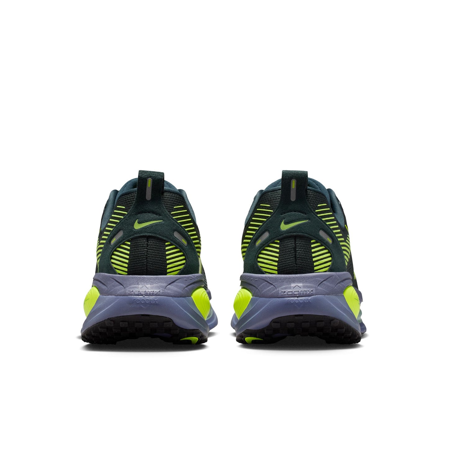 Pair of black and green running shoes on a white background