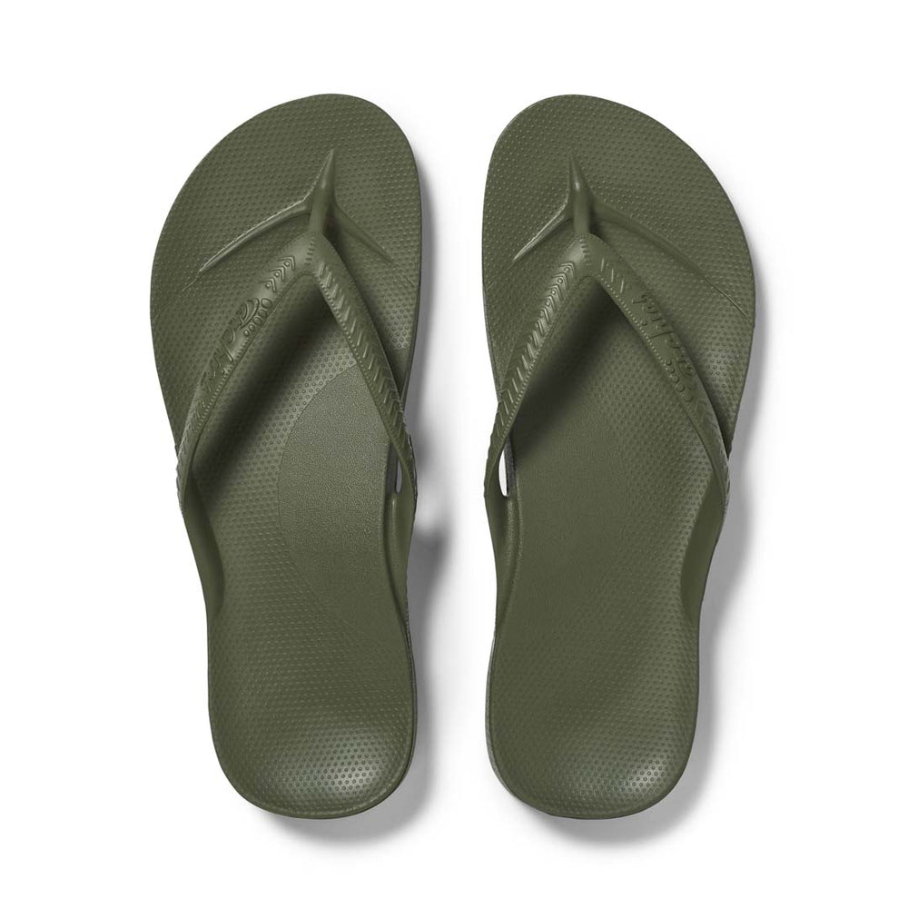 Pair of green flip-flops on a white background