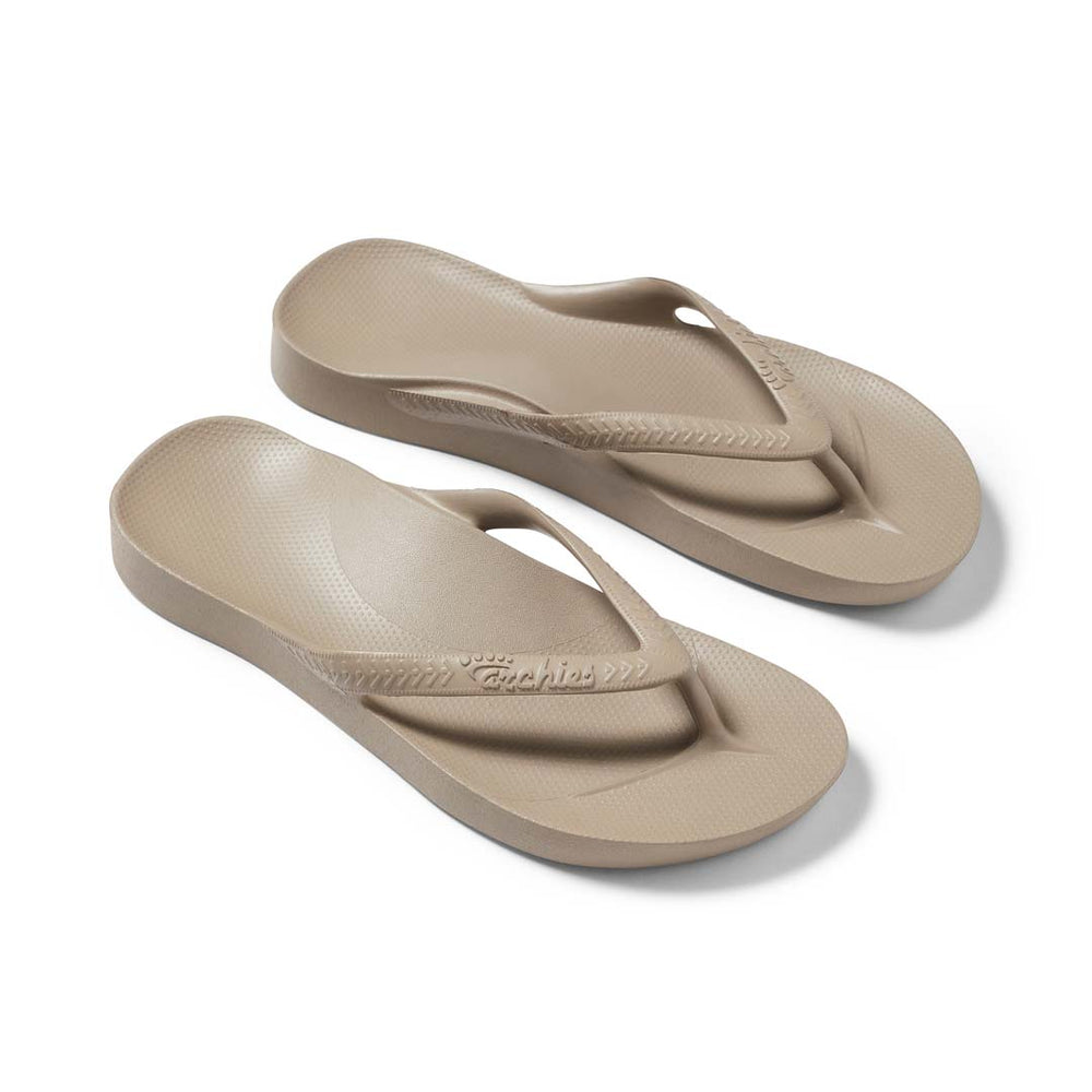 Pair of beige flip-flops on a white background