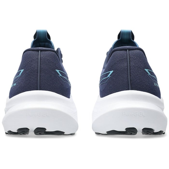 Navy running shoes with white soles on a white background