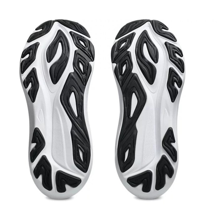 Close-up of white and black athletic shoes with unique tread pattern on a white background