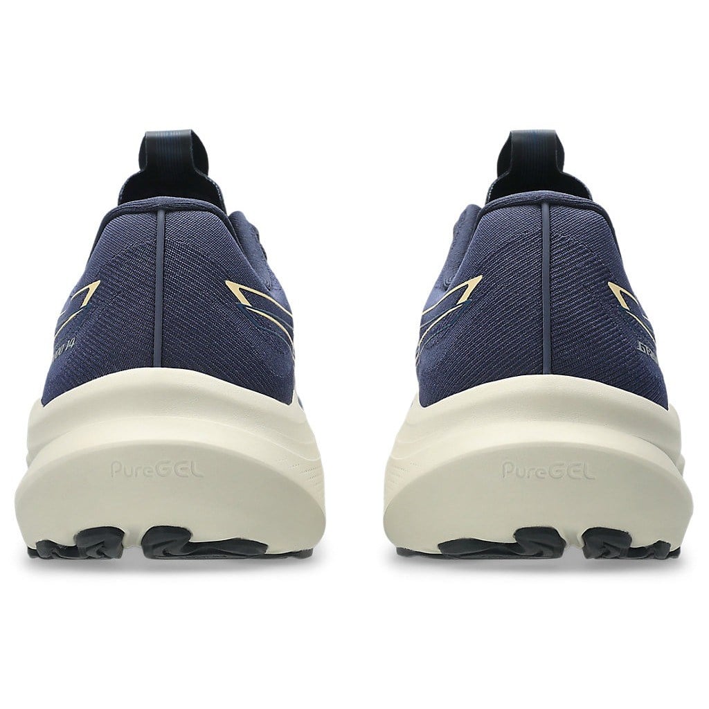 Navy running shoes with white soles on a white background
