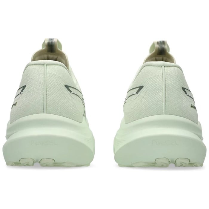 Light green running shoes with brand logo on a white background