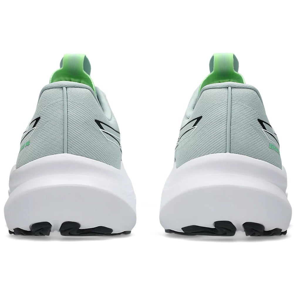 Light gray running shoes with green accents on a white background