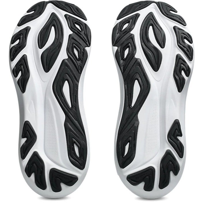Close-up of a pair of white and black athletic shoes with unique sole design on a white background