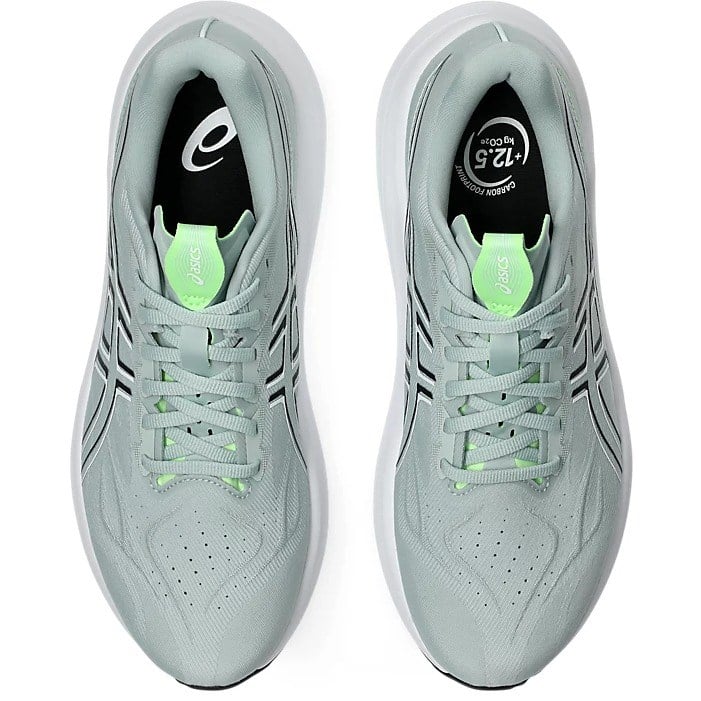 Pair of light blue running shoes with green accents on a white background