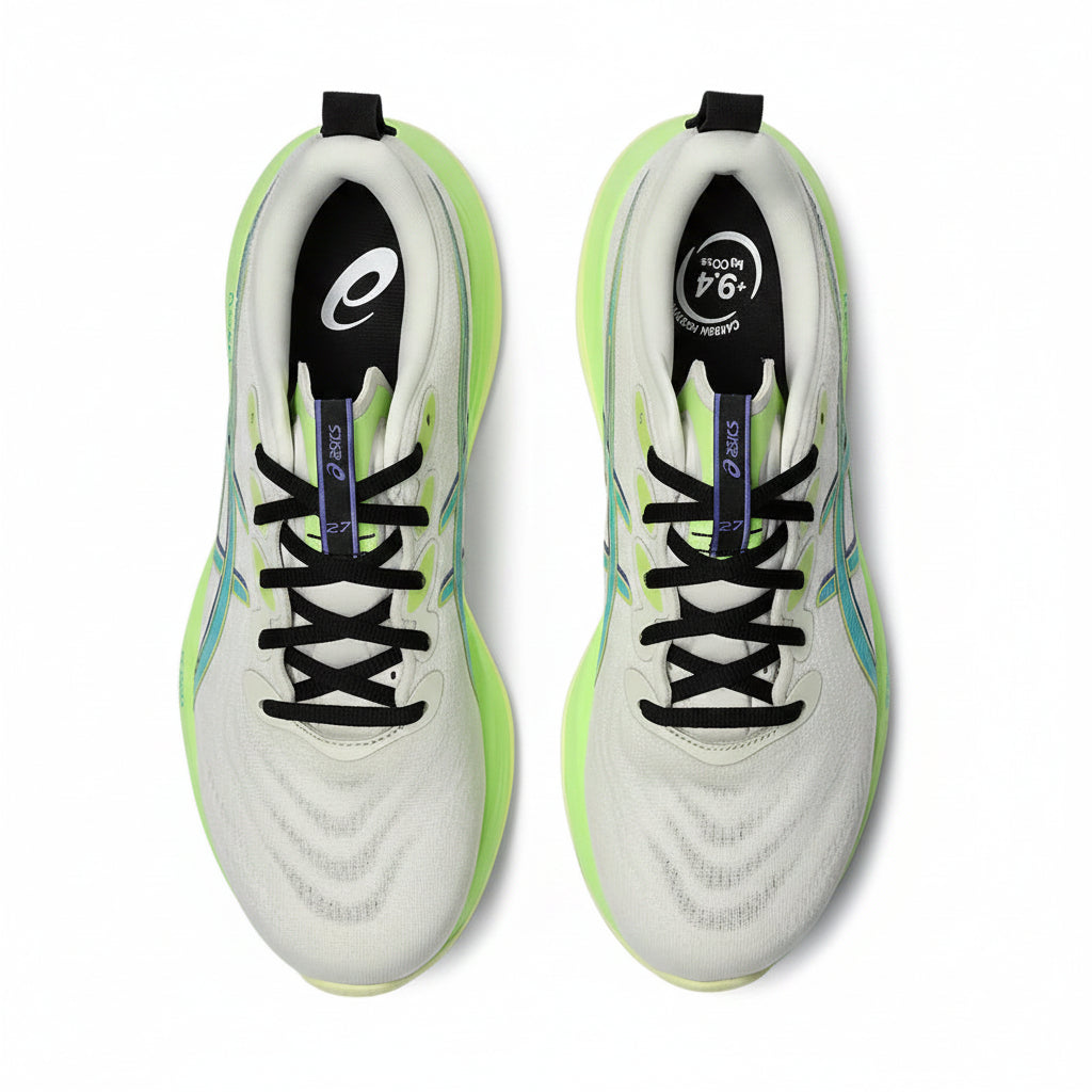 White soccer cleats with green accents on a white background