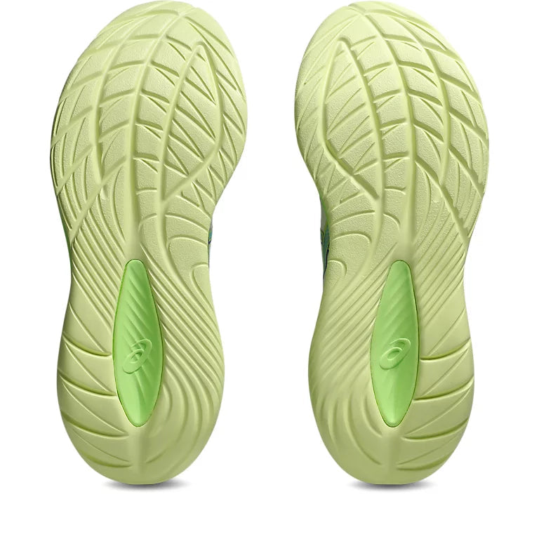 Close-up of green athletic shoes with sole pattern on a white background