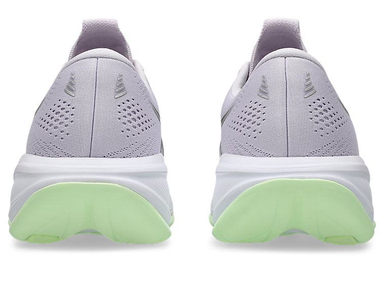 Light gray running shoes with green sole on a white background
