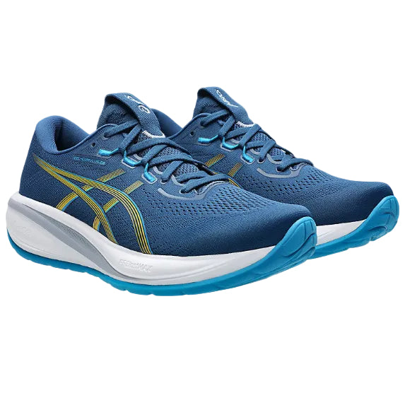 Blue running shoes with white soles on a white background