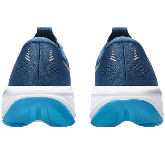 Blue running shoes with white soles on a white background