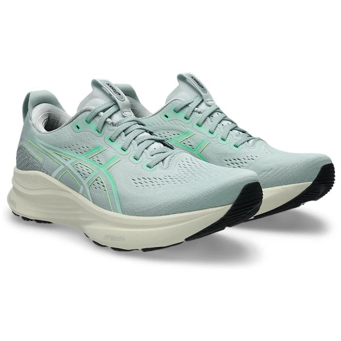 Pair of light blue running shoes on a white background