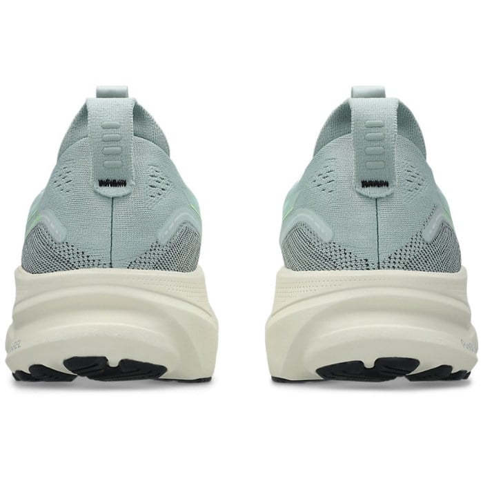 Light blue running shoes with white soles on a white background