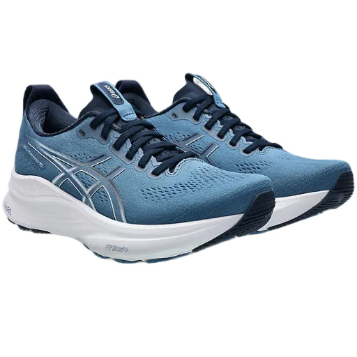 Blue running shoes with white sole on a white background