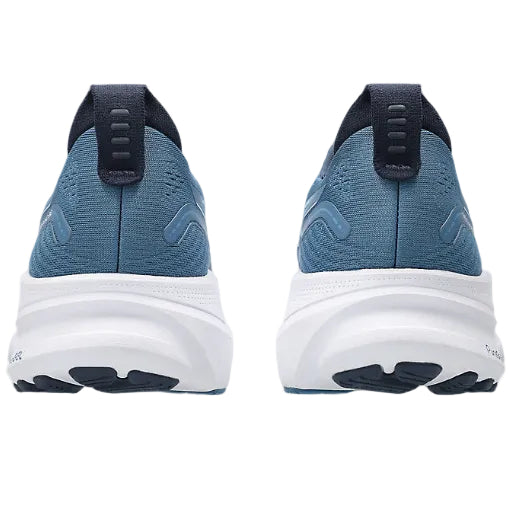 Blue running shoes with white soles on a white background