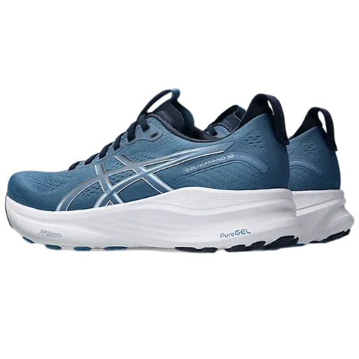 Blue running shoes with white sole on a white background