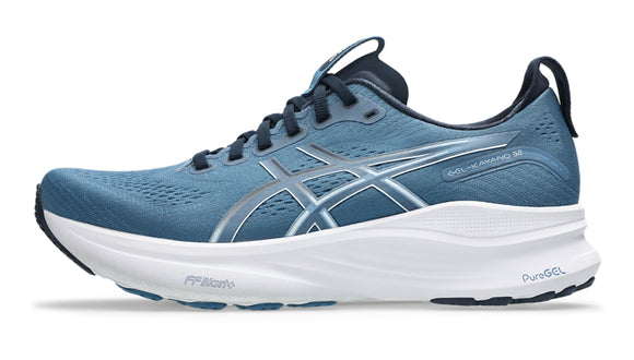 Blue running shoe with white sole on a white background